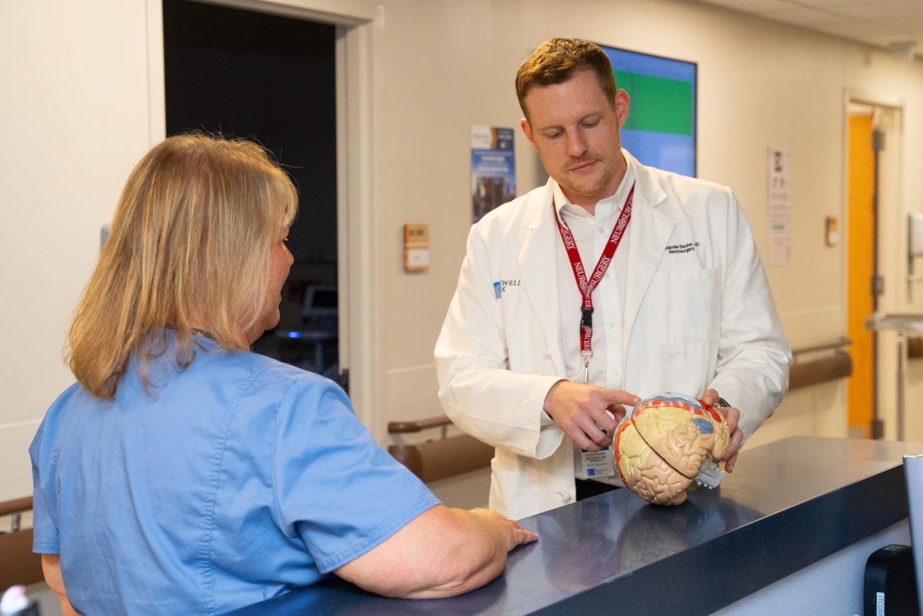A doctor explains a brain tumor to a nurse