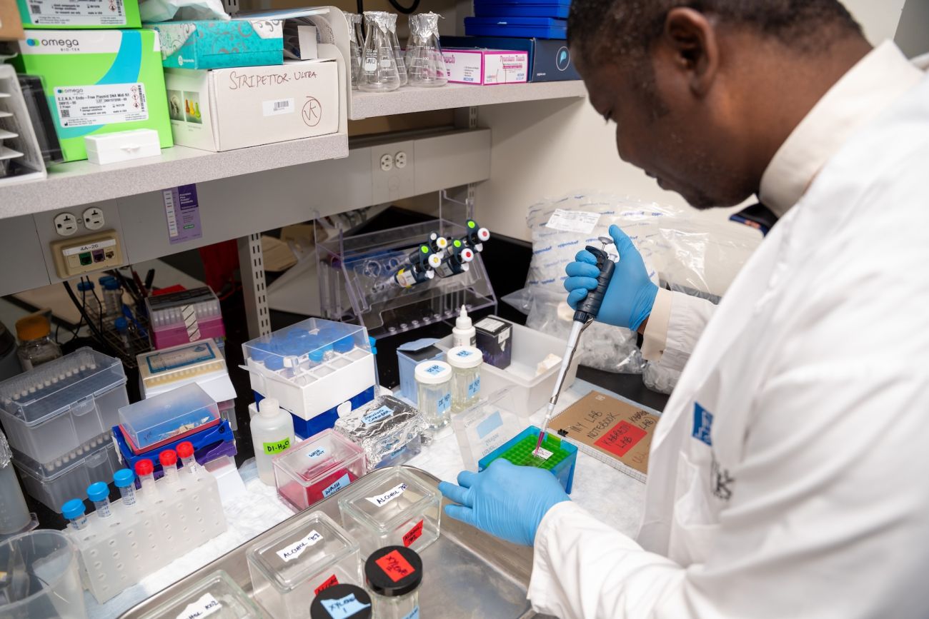 A scientist working at a lab bench.