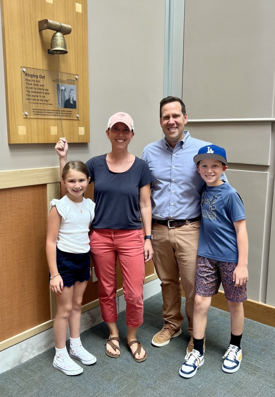 Breast cancer patient Jill Komm rings the Victory Bell with her family 