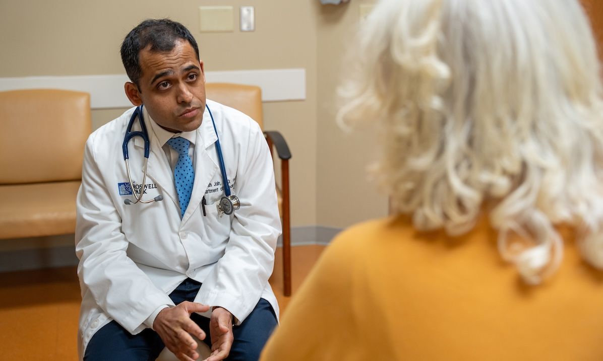 Dr. Prantesh Jain in clinic with patient 