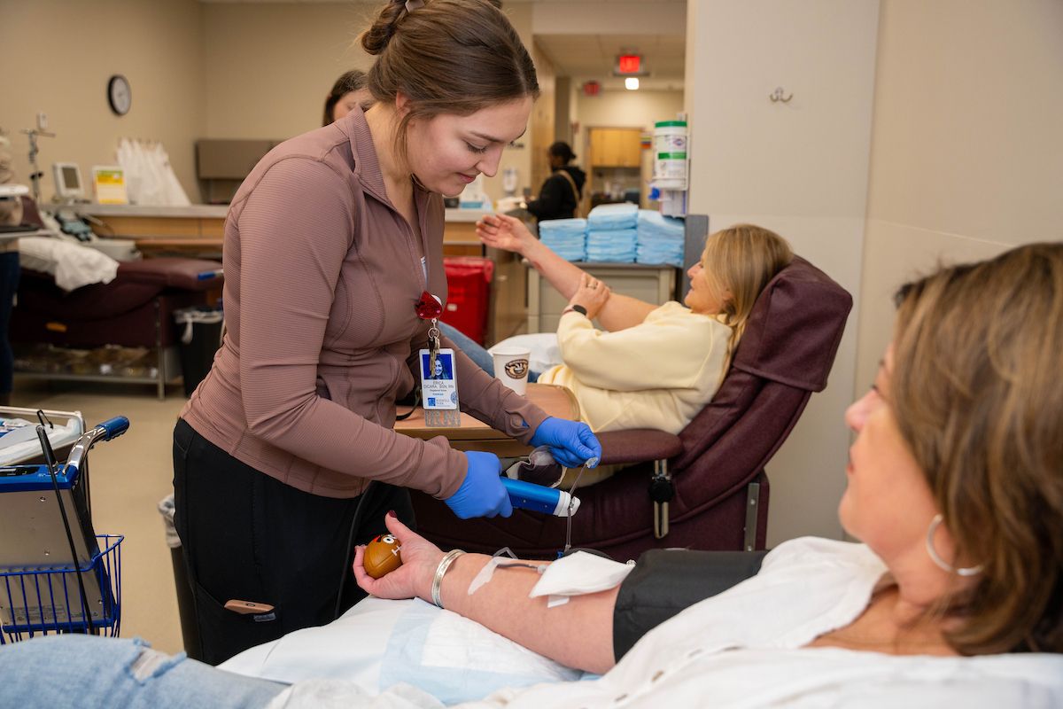 A nurse in the Donor Center tends to a patient that is donating blood 