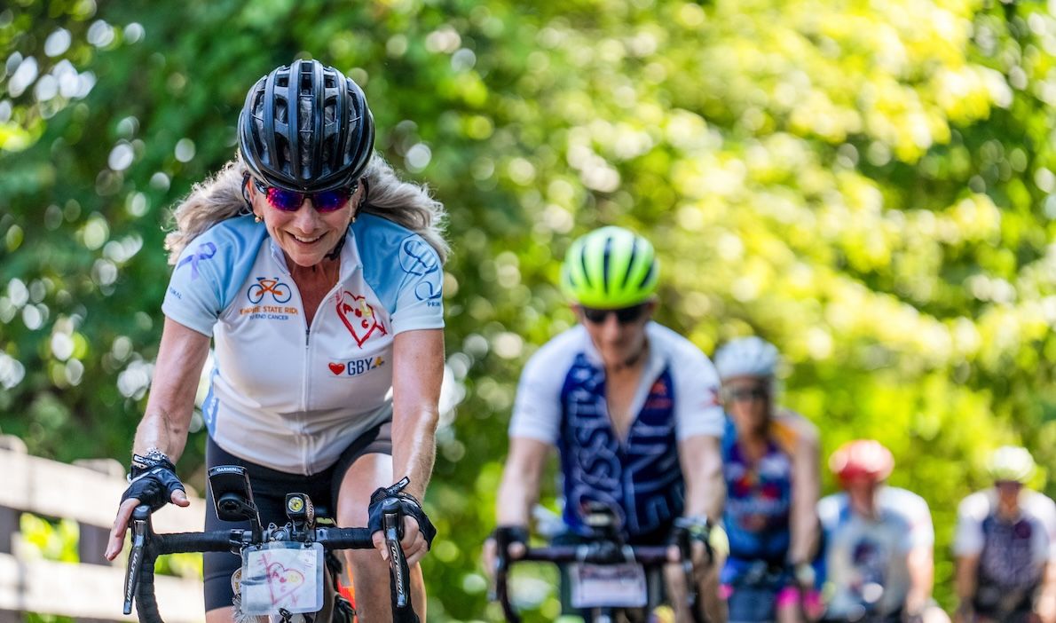 Woman riding a bike in a line of people during the Empire State Ride