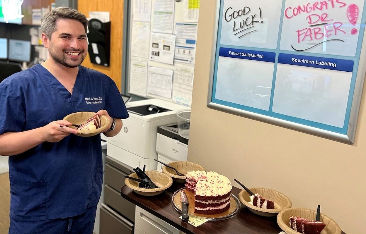 Man with a piece of cake for a farewell party