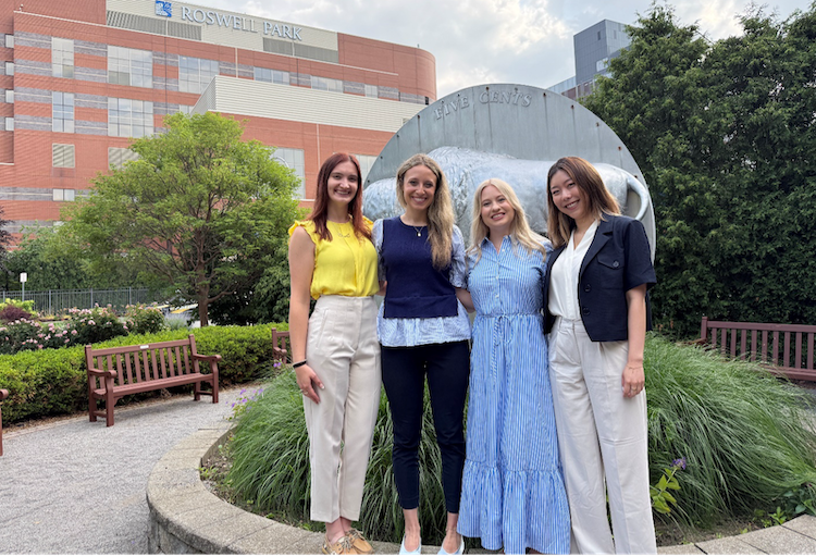 Four female Pharamacy residents stand outside of Roswell Park for a group photo 