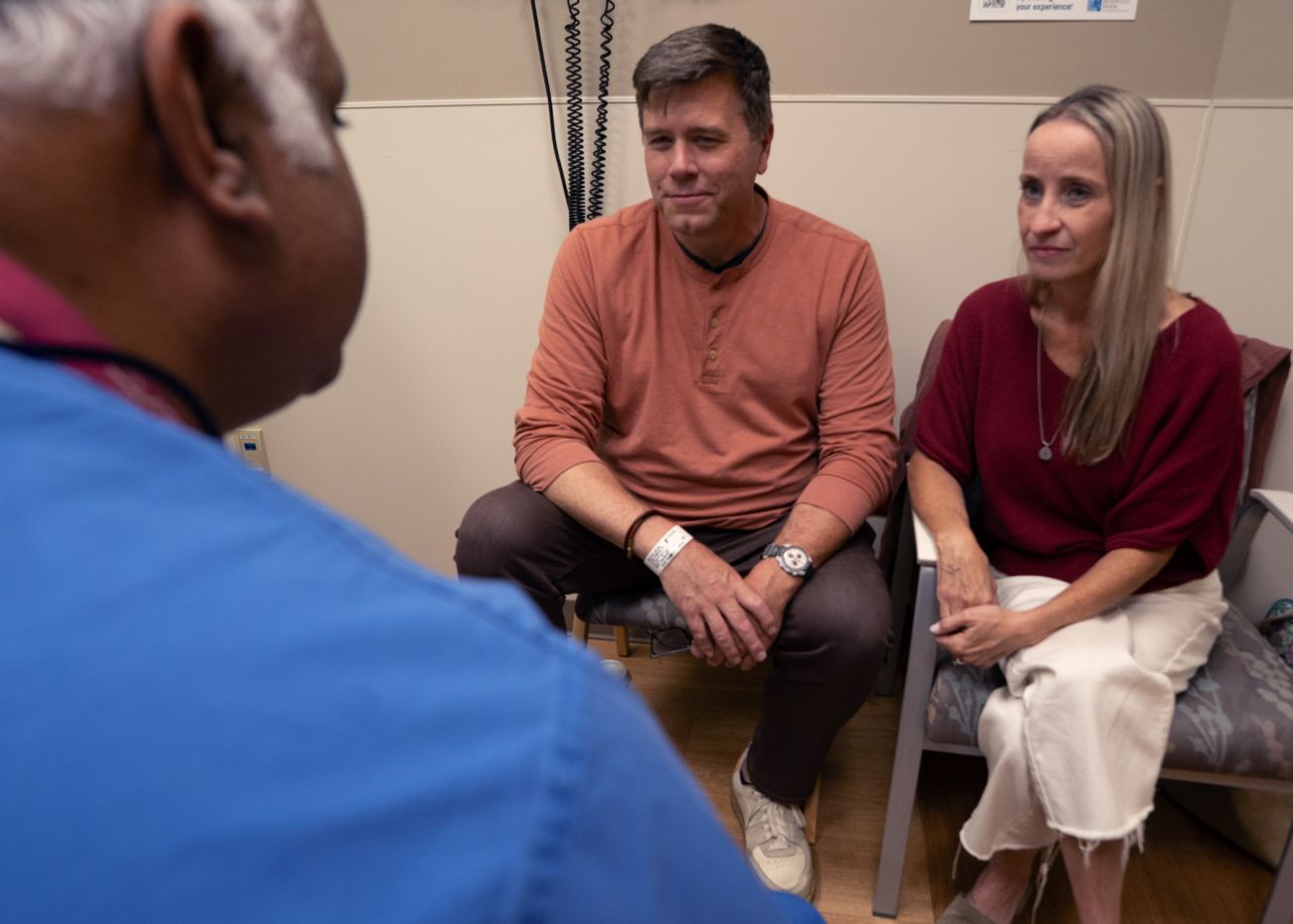 Husband and wife speak to doctor