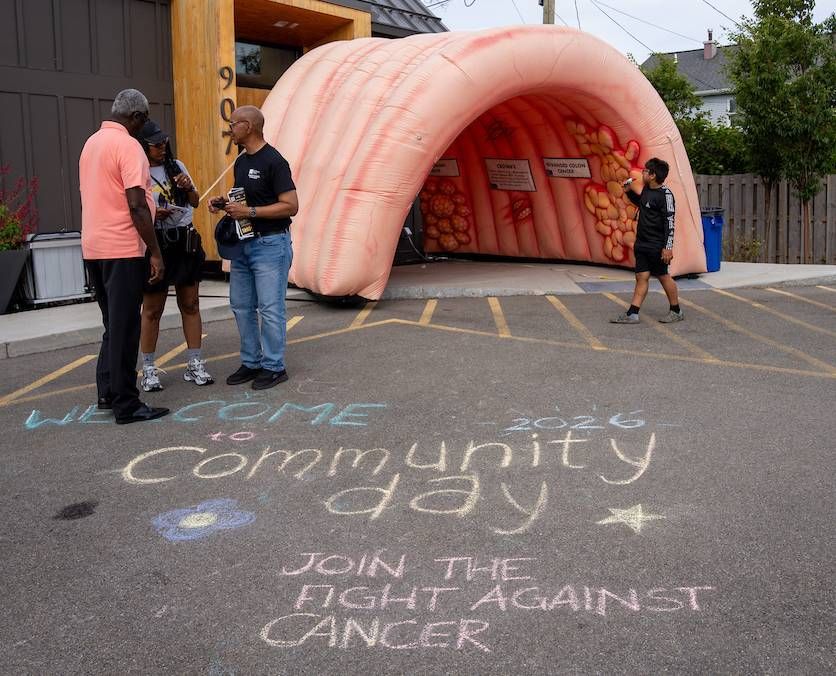 The inflatable colon is positioned in front of 907 Michigan, along with some chalk art, for Community Day.