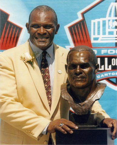 Harry Carson poses with his Football Hall of Fame bust in Canton, OH.