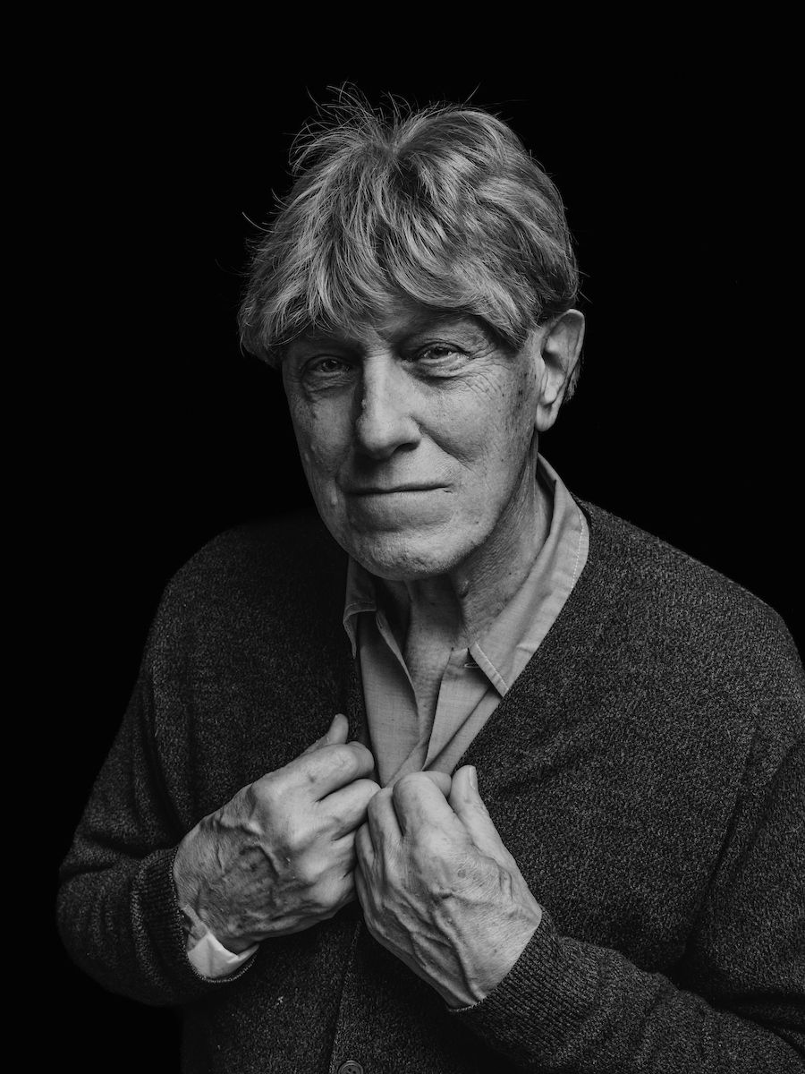 Black and white photo of Jackie with his hand on his face posing to promote the Elevate Salon