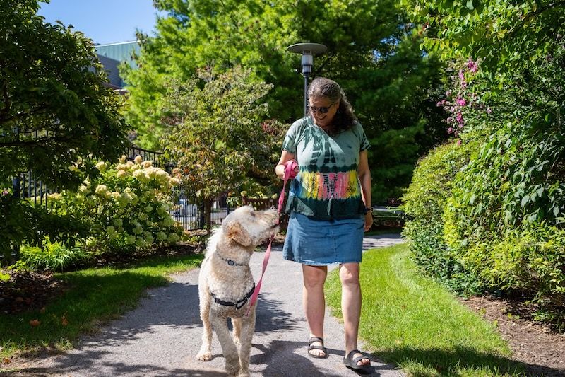Ovarian cancer survivor Julie Francisco walks her dog, Morty, in Kaminski Park
