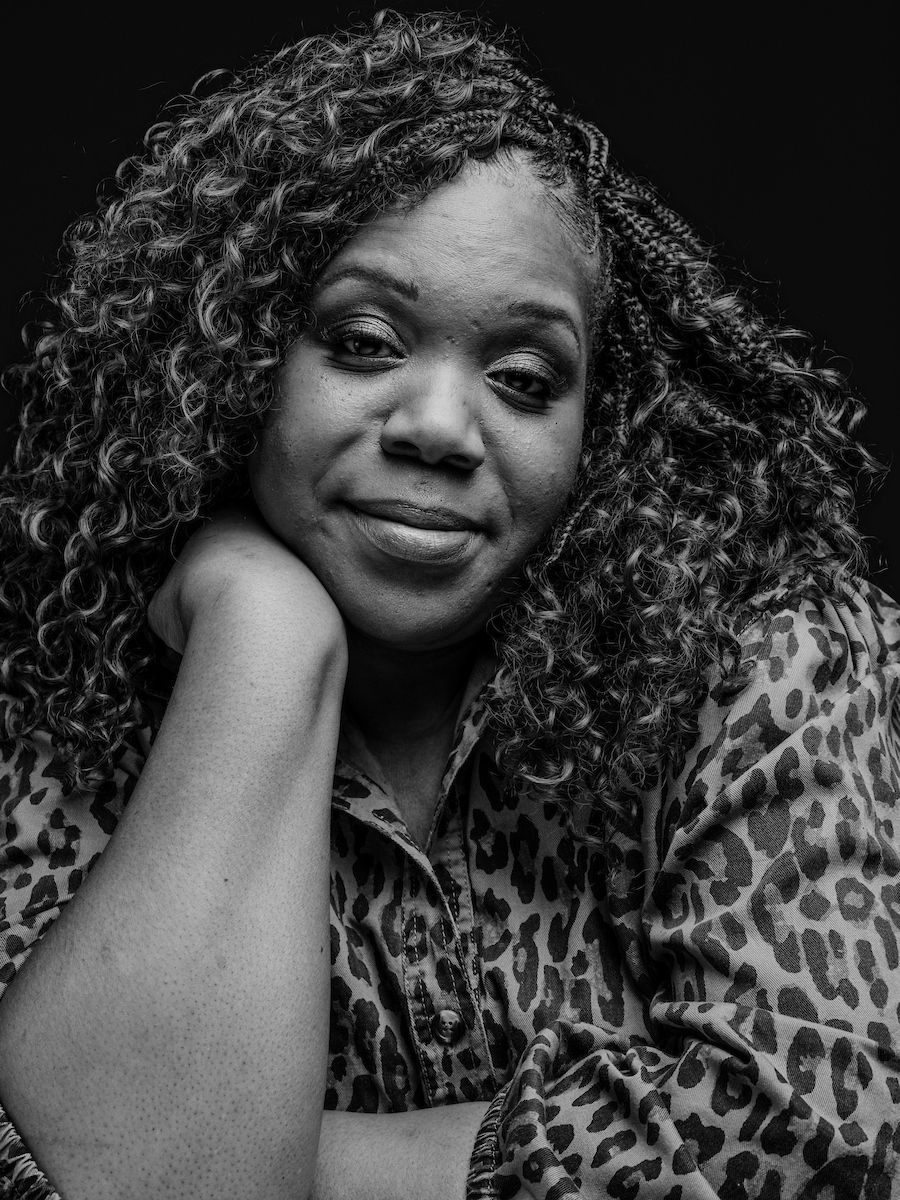 Black and white photo of Leah White posing in the studio to promote the Elevate Salon