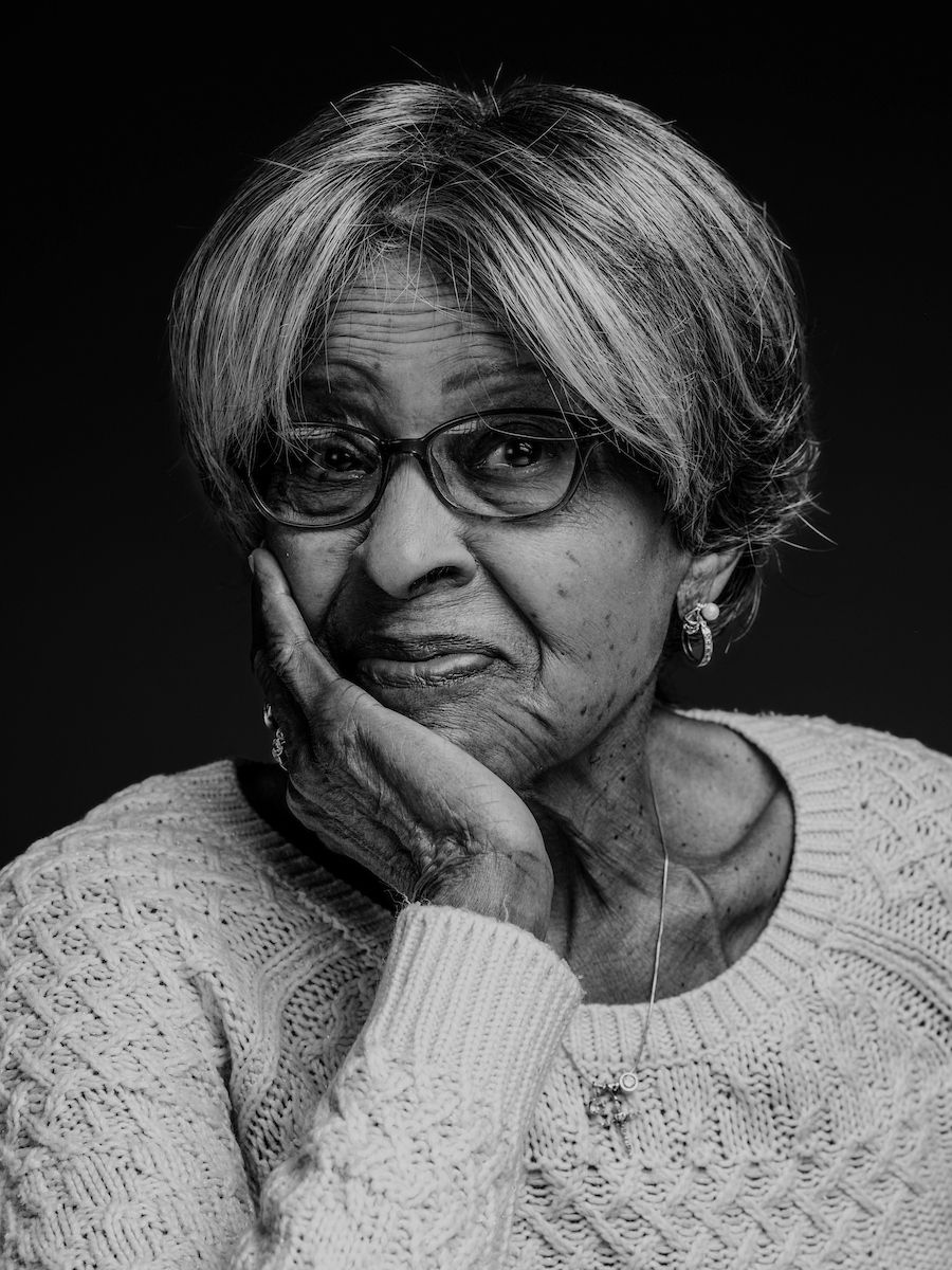 A black and white photo of Mrs. Clark posing for the camera to promote the Elevate Salon
