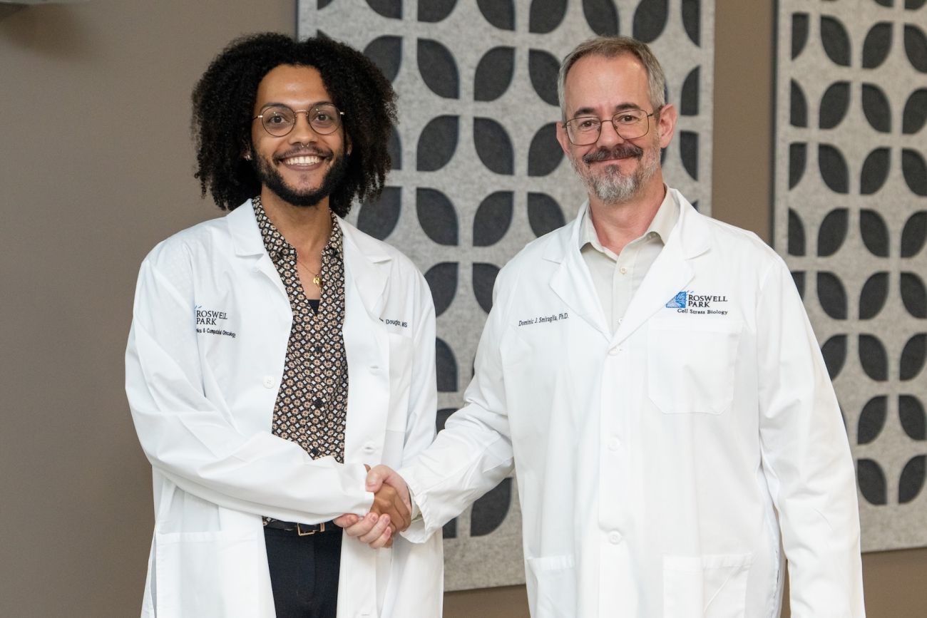 A recent medical graduate shakes the hand of his memtor