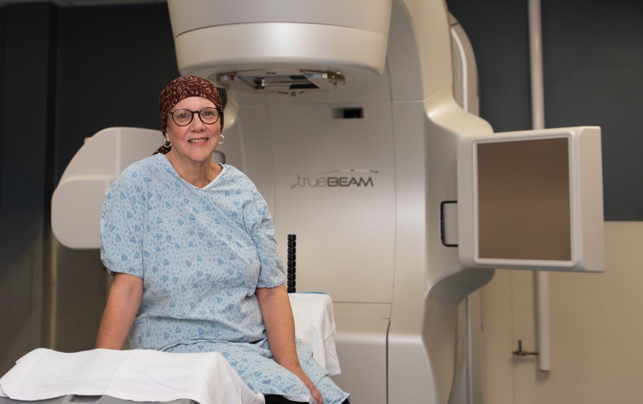 Breast cancer patient and Senior Science Writer Sue Banchich poses for a photo before her radiation treatment