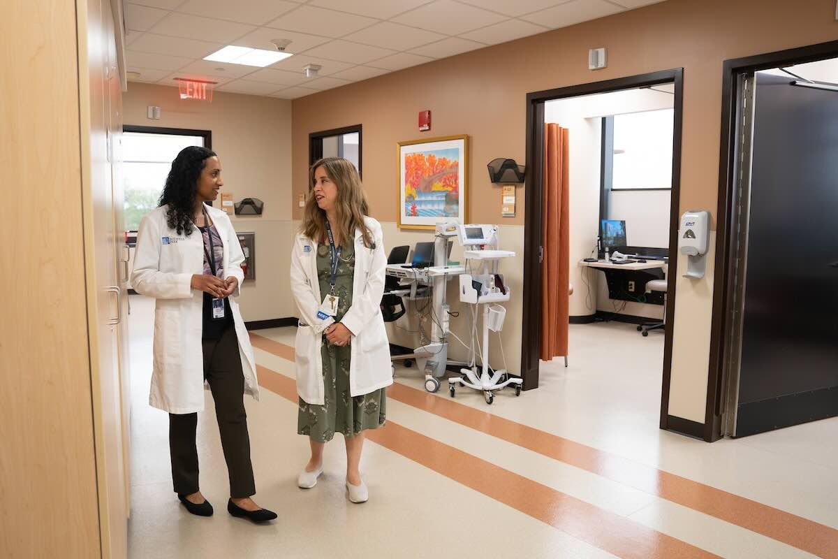 Two doctors walk down a hospital