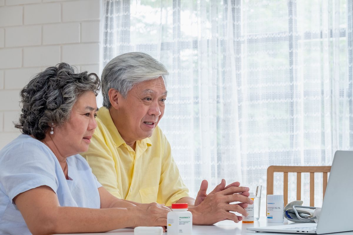 Older couple engaged in video chat with someone