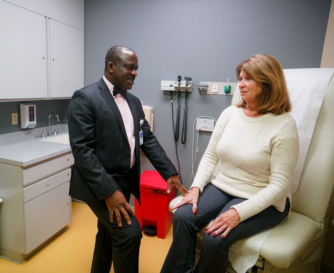 Dr. Chumy Nwogu speaks with patient in exam room