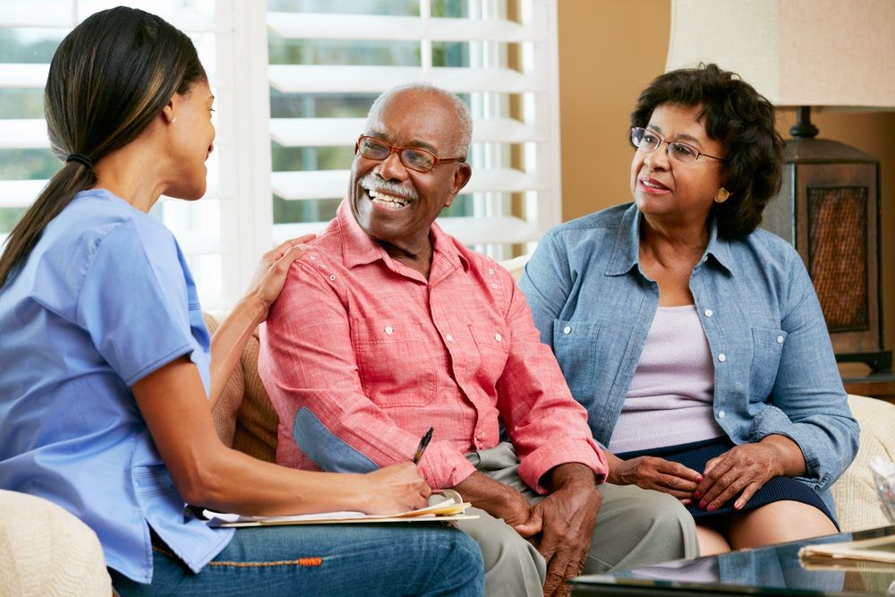 Older couple talking with healthcare professional