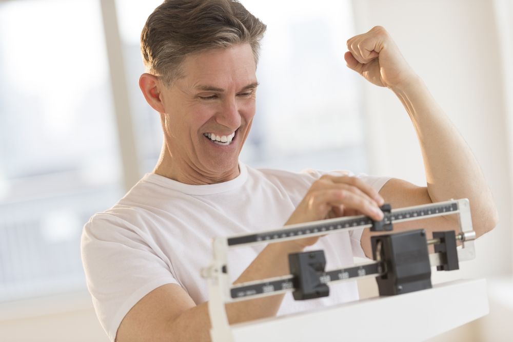 Person excited about reading their weight on a scale