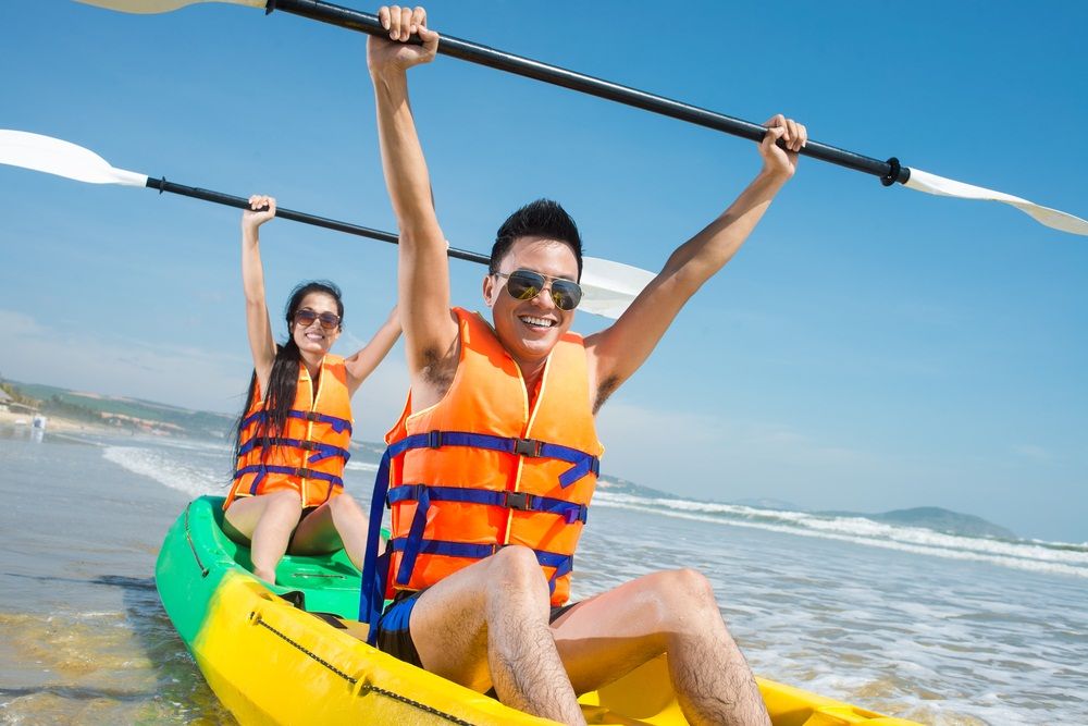 Two young people excitely canoeing