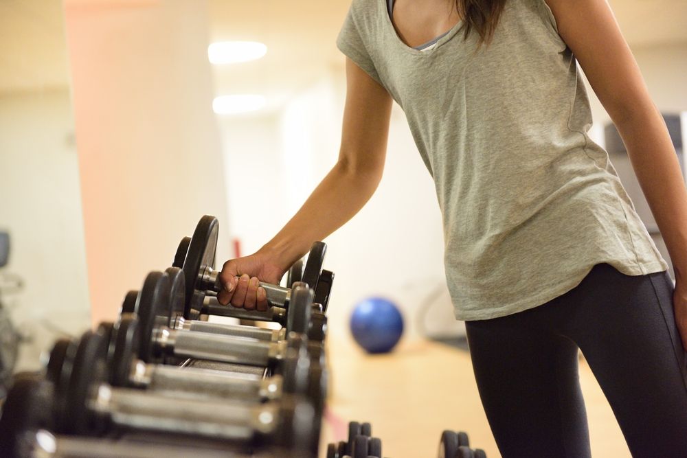 Person selecting a weight at the gym