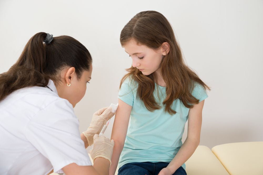 Medical professional giving a vaccination to a child