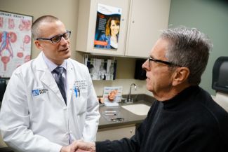 Dr Schwaab in clinic with patient