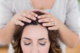 Woman getting reiki therapy
