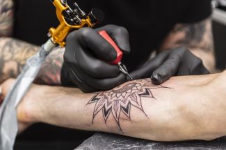 Person getting tattoo on forearm