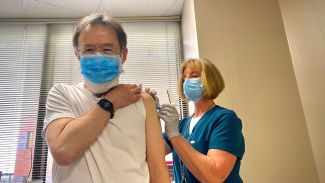 Dr. Philip McCarthy receives the COVID-19 vaccine.