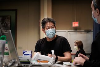 A man waits to receive the COVID-19 vaccine.