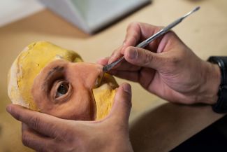 A facial prosthesis is being sculpted for a patient with head and neck cancer