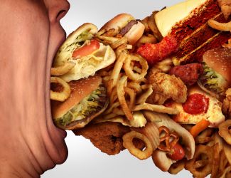Man shoving junk food in his mouth