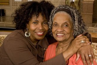 A younger woman and an older woman posing for a picture together