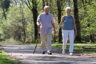 Two older people walking outdoors for exercise
