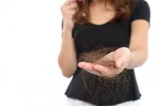 Person holding a handful of shed hair