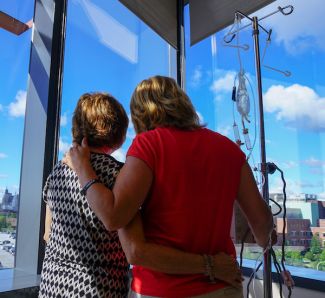 Patient with a loved one looking out the window