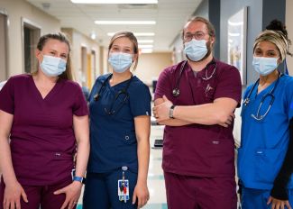 Group of nurses stand next to each other
