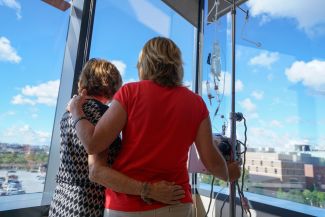 Two women in chemo look out the window