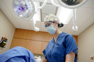 Dr. Kimberly Brady performs a procedure on a patient
