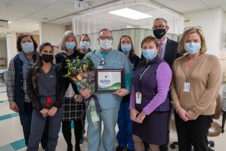 Vince Paluch, center, was named Roswell Park's Nurse of the Month for December. He's joined by members of his Interventional Radiology team and Dr. Candace Johnson, Roswell Park President and CEO. 