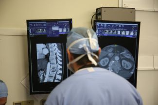 Doctor looking at screens during an operation