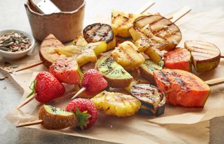 Fruit on skewers after being grilled - stock
