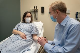 Doctor speaking with a patient in an exam room