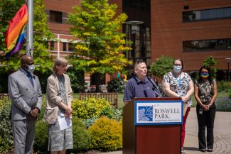 Susan Frawley, center, speaks during a Pride flag raising ceremony. She is joined by, from left, David Scott, Director of Roswell Park's Department of Division, Equity & Inclusion; Roswell Park President and CEO Candace S. Johnson; Rachel Parrino, Diversity, Equity & Inclusion Administrator, and Maansi Bansal Travers, a health behavior specialist. 