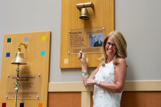 Breast cancer patient Jody Czaja ringing the Victory Bell - June 6, 2022