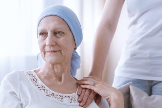 Older lymphoma patient with a family member - stock image