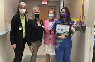 Nina Mohsini, far right in blue scrubs, was named Roswell Park's Nurse of the Month for August. 