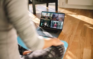 Virtual yoga and mindfulness session on a computer - stock 