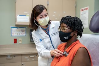 Dr. Katherine Lavigne Mager with a patient in clinic - August 2022