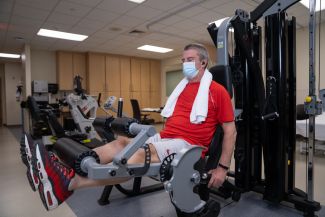 Patient using machine in new rehab therapy space - April 2021